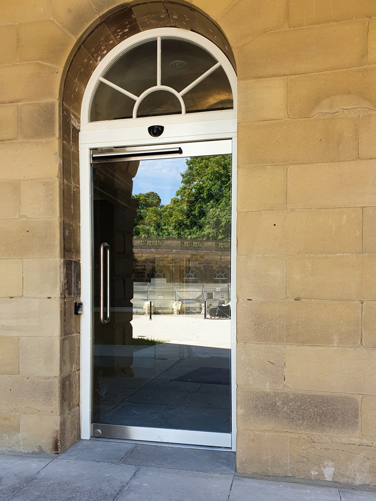 Powered glass door for historic building